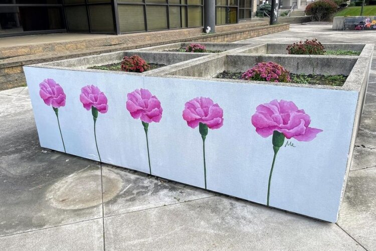 Flower boxes on City Hall Plaza were recently wrapped in artwork submitted by local artists and selected by the Public Arts Committee.