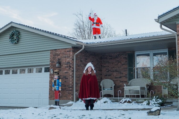 Kevin Elliott play rooftop Ramar Santa while his wife, Angela, dresses in her Mrs. Claus cape on weekend nights while the neighborhood is lit up.