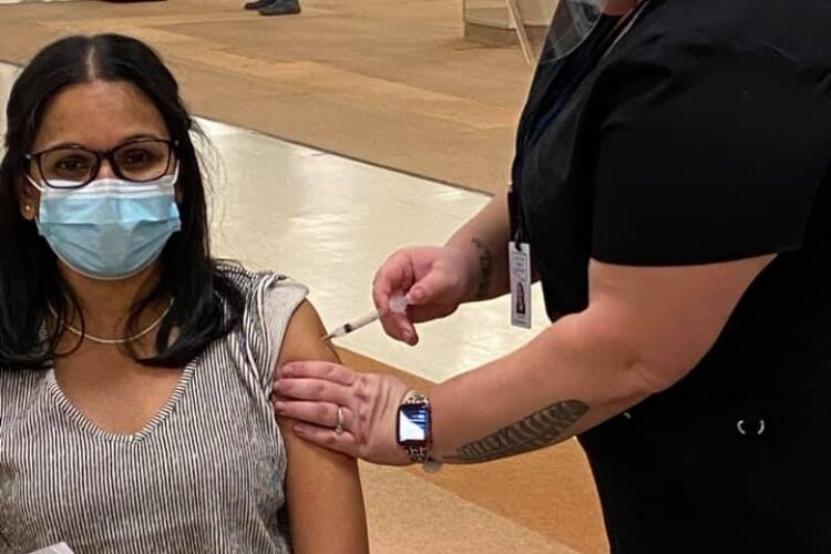 Dr. Yamini Teegala, Chief Medical Officer for Rocking Horse Community Health Center, gets a COVID-19 vaccine.