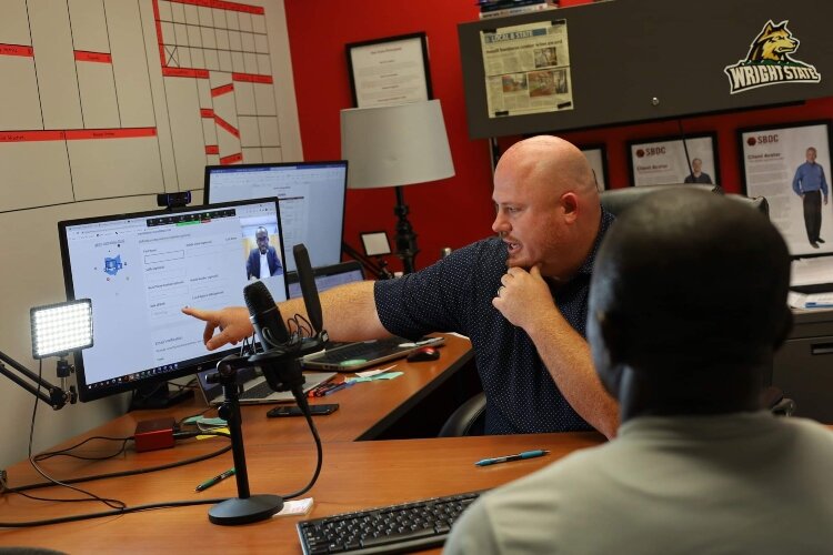 Rob Alexander, executive director of Springfield's Small Business Development Center, provides business coaching to a Haitian entrepreneur with assistance from a virtual translator. 