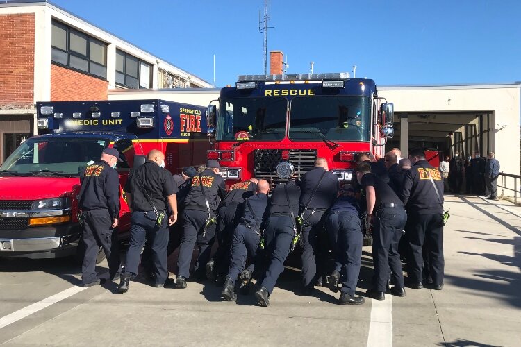 The Springfield Fire Rescue Division team from Station One welcomed their new fire rescue pumper truck into the station with a traditional company push.