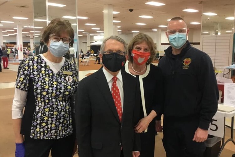Springfield Fire Rescue Division Firefighter/Paramedic Jim Frantz (right) and another healthcare worker (left) were visited by Ohio Governor Mike DeWine and First Lady Fran DeWine at Clark County's COVID-19 vaccination clinic at Upper Valley Mall.