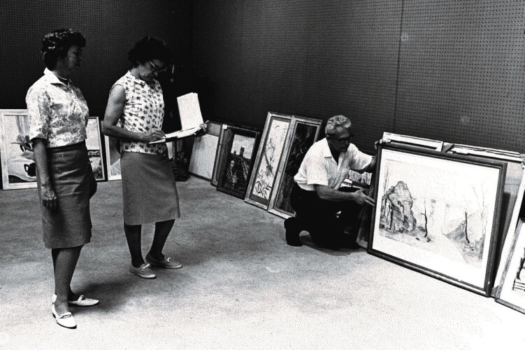 The Springfield Museum of Art's Members' Juried Exhibition is an important part of the history of the museum. This image shows entry lists being check at a past exhibition.