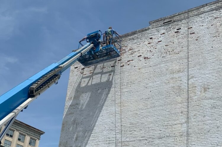 The wall on the back of The State Theater where a new pice of public art will be painted had to be repaired and prepped for the upcoming project.