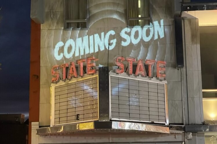 In one movie projection on the front of The State Theater, 'Coming soon' appeared above the marquee.