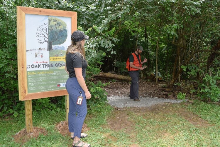 Ohio Department of Natural Resources Service Forester Pat Migliozzi tells ODNR Director of Special Project Alyssa Yaple about maple leaves that have fallen from the maple trees along the new Storybook Trail at John Bryan State Park.