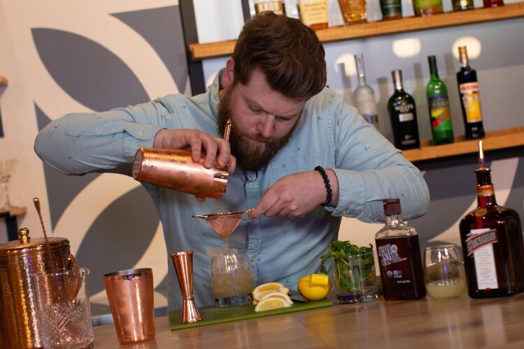 Andrew Lazear, co-creator of The Market Bar, works on making handcrafted, unique cocktails.with fresh ingredients.