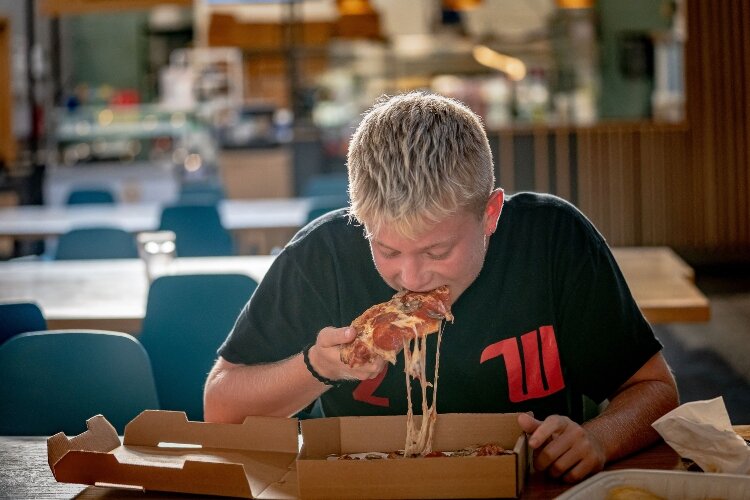 Bobby Goodman - a Wittenberg University student - popped in COhatch - The Market to enjoy some pizza from Crust & Company. 