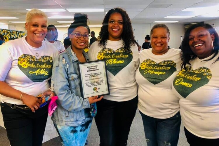 Camille Hall, second from left, to God's Creations Hair and Beauty Bar, located at 1810 S. Limestone St.