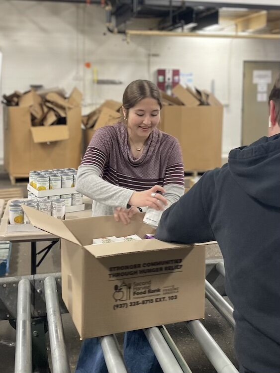 Twenty-three students dedicated their time to pack 200 boxes of food, contributing to the ongoing efforts of Second Harvest in fighting hunger.